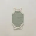 Close-up detail of infant sleeveless tank bodysuit, soft green knit fabric with contrast trim. - Bean Green Romper