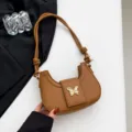 Brown underarm shoulder bag with trendy butterfly metal decor and stylish knot strap. - Brown