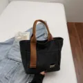 Casual canvas tote bag for women, stylish brown handles, lightweight daily commuter handbag. - Black