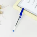 Blue plastic ballpoint pen with transparent barrel for office and school study use. - Blue