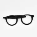 Close-up detail of black eyeglasses shape tie clip, stylish and unique gentleman accessory. - Black