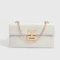 Stylish white women crossbody bag with gold chain strap and chic geometric metal lock. - White