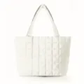 Closeup of the minimalist white quilted puffer tote bag, showing soft padded texture. - White