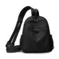 Black nylon small backpack variant, lightweight multi-compartment casual daypack for women commuting. - Black