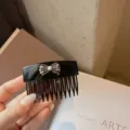 Elegant black acrylic hair comb featuring a sparkling rhinestone and pearl bow design for women. - Classic Black