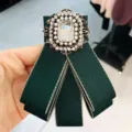 Vintage green fabric bow brooch with sparkling rhinestones, pearls and a large crystal center. - Dark Green