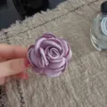 Purple fabric camellia brooch and hair accessory detail shot, elegant floral design. - Light Purple