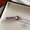 Close-up detail shot of the purple fabric bow hairpin with sparkling rhinestone ring accent. - Dusty Pink