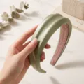 Detailed view of the padded satin hair hoop with chic texture, elegant green hair accessory. - Mint Green