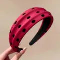 Detailed view of the red polka dot headband, soft fabric texture and wide padded design. - Burgundy