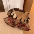 Close-up detail of the autumn winter tweed bow hair hoop with plastic teeth for secure grip. - Red