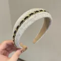 Chic tweed hair hoop with interwoven gold chain and black ribbon, elegant wide headband for women. - Off White