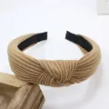 Detailed close-up view of the wide knit headband featuring a stylish knotted design in khaki. - Khaki