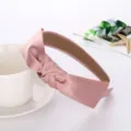 Pink satin knotted headband detail shot, minimalist daily hair accessory, elegant look. - Pink