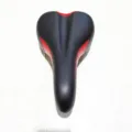 Detail view of black and red bicycle saddle cushion, featuring ergonomic central groove. - General Purpose / Red