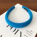 Detailed close-up view of the solid blue wide padded fabric headband and interior texture. - Azure Blue