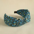 Close-up detail of a floral print knotted headband, elegant wide hair hoop for daily wear. - Sapphire Blue