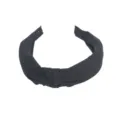 Detailed view of black knotted wide headband, simple design for daily wear and face washing. - Black
