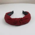 Detailed shot of a stylish burgundy twill knotted fabric headband for women daily wear. - Brick Red