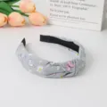 Grey knotted hair hoop with butterfly and daisy print, chic fashion accessory for women. - Gray