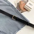 Classic women's black perforated leather belt, versatile fashion accessory for jeans and casual wear. - Black