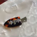 Tortoise shell hair clip detail showing metal flowers and sparkling crystal rhinestones. - Tortoiseshell (Single)