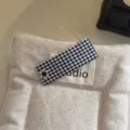 Primo piano dettaglio del fermaglio per capelli BB in tessuto a quadri vichy nero bianco floreale. - Nero Sesamo