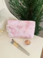 Detail shot of a pink canvas cosmetic pouch featuring delicate gold and butterfly embroidery. - M / Glitter Butterfly