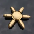 Close-up detail of a solid brass bullet shaped fidget spinner toy, smooth metallic mechanical spin. - Pure Copper Detachable - CT-05 Bullet Model