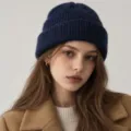 Close-up detail of the dark blue wool blend knitted beanie worn by model, showing texture. - S (54-56cm) / Deep Sea Blue