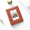 Detailed shot of retro brown mini photo album with clear pocket, texture view and styled props. - Retro Reddish Brown