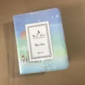Detail view of the 3-inch mini photo album card collector book with starry sky winter design. - Snow Village
