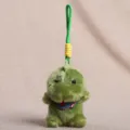 Süßer grüner Plüsch Dinosaurier Schlüsselanhänger mit Schal, weiche Spielzeug Tasche Charme neu. - Schal Tieranhänger - Dinosaurier