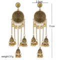 Gedetailleerd overzicht van vintage Indiase Jhumka kwastoorringen met prachtig etnisch design. - Antiek Goud