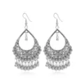 Detailed close-up of vintage silver boho teardrop earrings with delicate cutouts and beads. - Style 1
