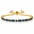 Elegant gold-plated slider bracelet featuring alternating blue zircon stones and adjustable chain. - Blue