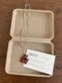 Detailed view of a cute brown bear pendant necklace with pearls and a gift card in a box. - Zirconia Bear Necklace (XL5780B)