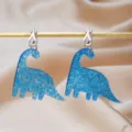 Pendientes de clip de dinosaurio con purpurina azul para niños, joyas de resina acrílica sin agujeros. - 2
