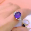 Elegant silver ring featuring a stunning oval purple gemstone and sparkling zirconia. - Mood Stone Ring / Open Adjustable / Silver