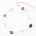 Detailed view of the gold-plated chain bracelet featuring natural stones and white beads. - Artificial Pearl + Tiger's Eye