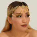 Close-up of the elegant gold coin head chain, showing intricate metalwork and sparkling rhinestones. - Gold