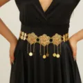 Detail view of the gold-plated cutout flower and coin tassel waist chain accessory. - Style ST311