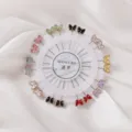 Colorful butterfly brooch pins set on a white round card, perfect for clothing and scarfs. - Butterfly Painted Pin 20pcs
