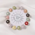 Colorful camellia flower brooch pins set on a white holder wheel for garment styling. - Pearl Camellia Pin 15pcs