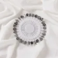 Vintage silver decorative pins set, various floral brooch needles on a clean white round holder. - Distressed Silver Set Pin