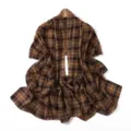 Detailed view of a brown plaid chiffon scarf, showcasing the soft fabric texture and drape. - Brown Yellow Plaid