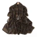 Detailed view of the lightweight brown plaid chiffon scarf shawl draped gracefully on hanger. - Coffee Green Plaid