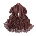 Detailed view of glossy pearlescent scarf with delicate white floral embroidery and scalloped edge. - Withered Rose
