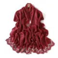 Close-up detail of a dark red long scarf featuring delicate white floral embroidery edges. - Valley Rose Red