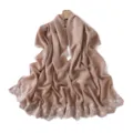 Detailed view of glossy pearlescent solid color shawl scarf with delicate white floral embroidery. - Mocha Mousse
